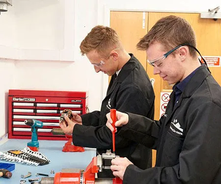 Domino apprentices working in factory